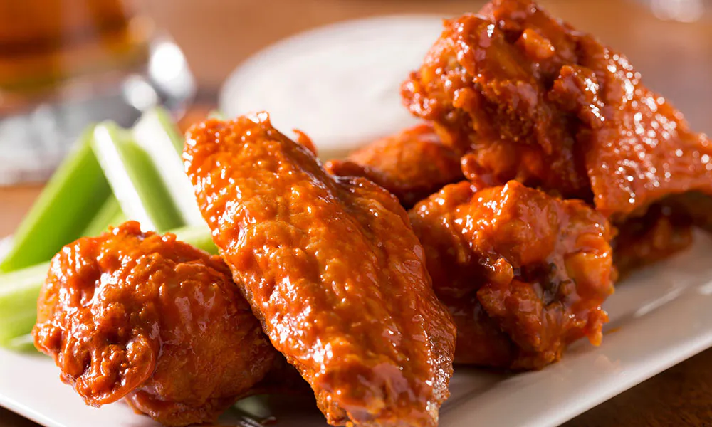 Spicy buffalo chicken wings served with celery sticks at Sumo Ramen CO, a Chinese Restaurant in Fayetteville